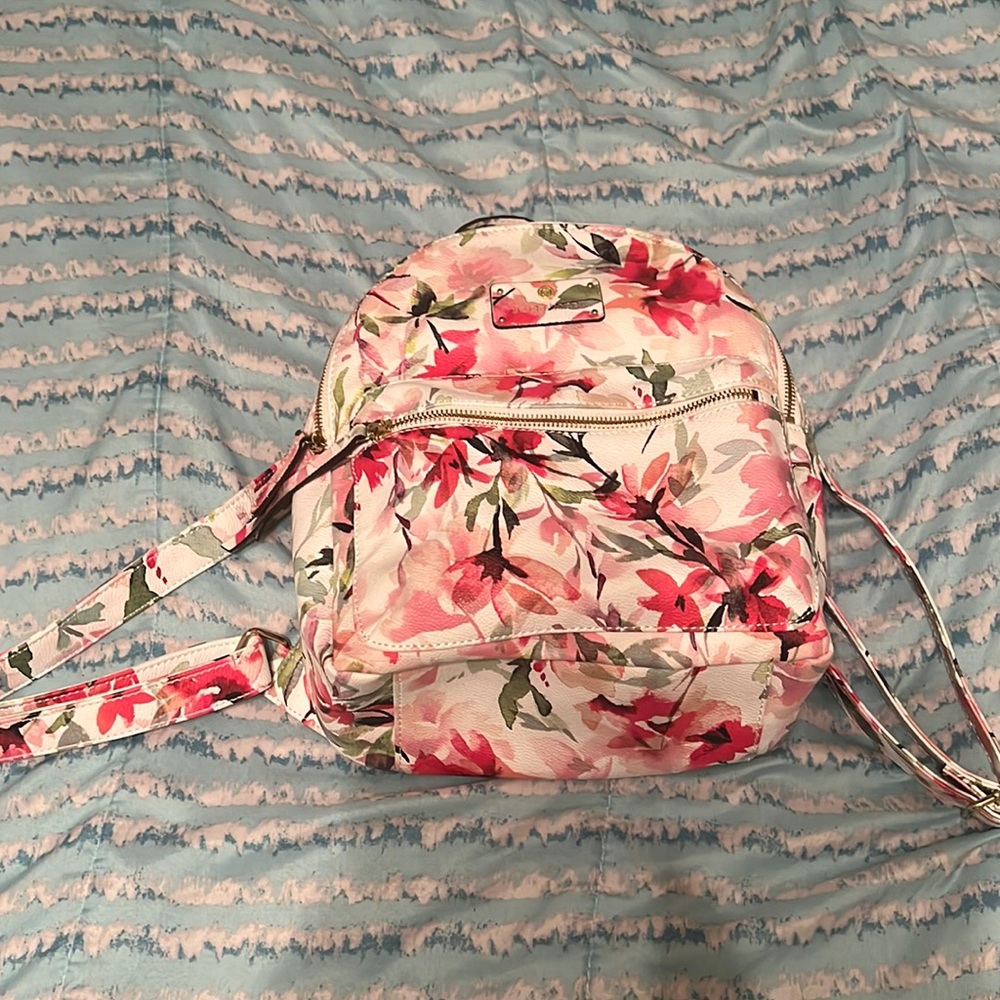 A white, pink and green floral mini backpack from Liz claiborne